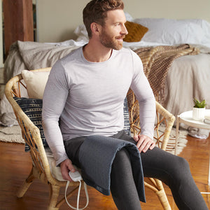 Man sits on chair with the Homedics 12