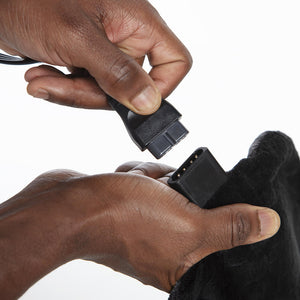 Hands connecting the detachable LCD controller to the Homedics Weighted Gel Back Wrap
