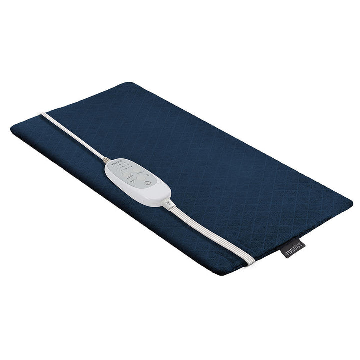Man stretches out on couch while enjoying massage from the Homedics 12 x 24 Weighted Massaging Heating Pad