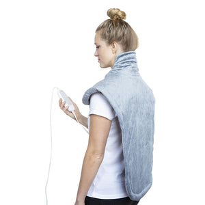 Side view of woman wearing the Homedics XL Massage Wrap with Heat Massage and holding the analog LED controller