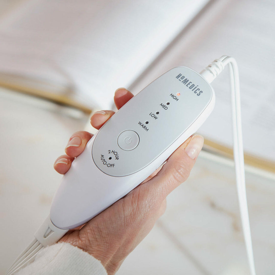 Close-up view of the analog LED controller for the Homedics Women's Health Comfort Heating Belt