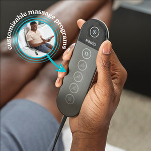 Hand holds the handheld controller for the Homedics Shiatsu + Kneading and Vibration Massage Cushion with Heat