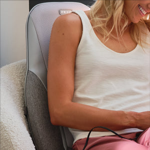 Close view of Woman relaxes her back on the Homedics Shiatsu + Kneading and Vibration Massage Cushion with Heat on chair