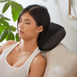 Woman enjoys neck massage from the body massager of the Homedics 2-in-1 Shiatsu Massage Cushion and Cordless Body Massager