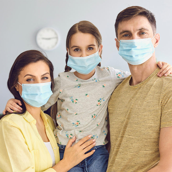 Family of three each wearing a Homedics Single Use Ear-Loop Face Mask (10 Count)