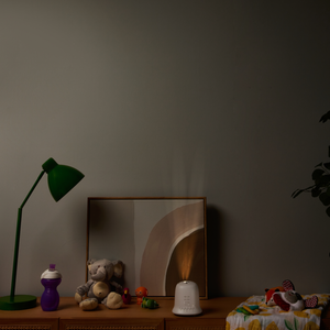 Night view of dresser in baby room with the Homedics SoundSpa® Lullaby with Sounds & Projection