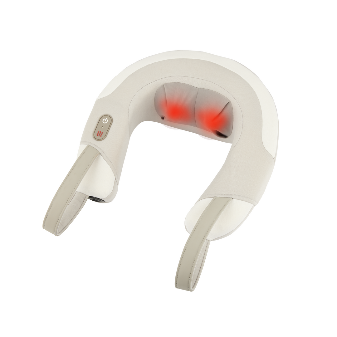 Woman sitting on her bed relaxing reading a magazine enjoying her Homedics Shiatsu Rechargeable Neck Massager with Heat