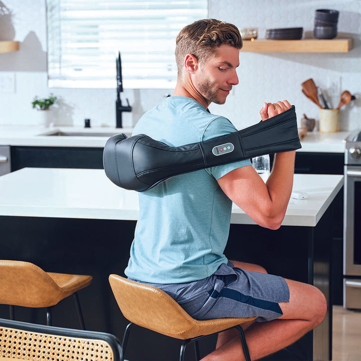 Man focses during intense mid-back massage using the Homedics Shiatsu Neck and Body Massager with Heat
