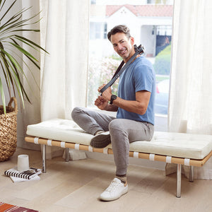 Man sits on chair and enjoys back massage from the Homedics Gentle Touch Gel Cordless Neck and Body Massager with Heat