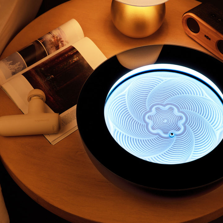 Cream | drift sandscape sand table sits on a nightstand with a magazine, massage gun, and House of Marley speaker next to it
