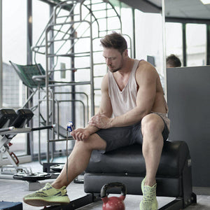 Man checks his pulse using the Homedics Pulse Oximeter during workout