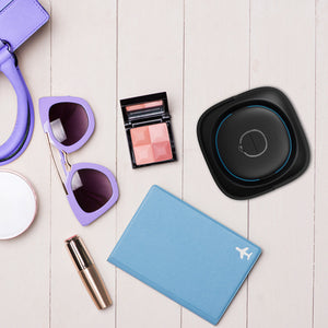 Top-down view of the Homedics UV-Clean Portable Sanitizer Wand with sunglasses, a notebook and other personal items