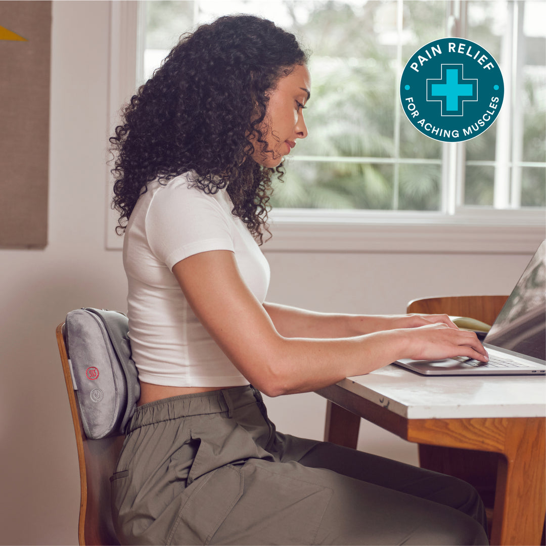Woman using the HoMedics Contoured Gel Massage Pillow for targeted pain relief.