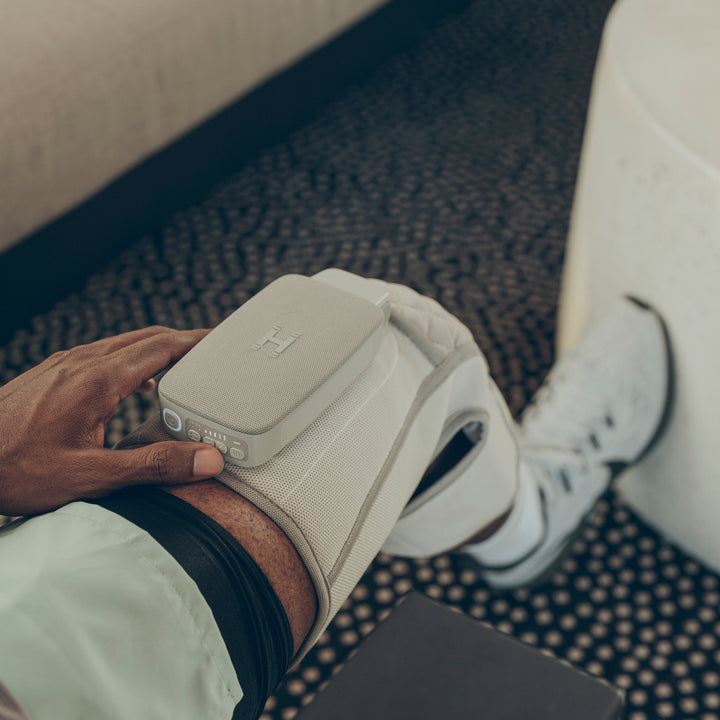 Over view of a mans knee using the Homedics® Modulair compression knee wrap.