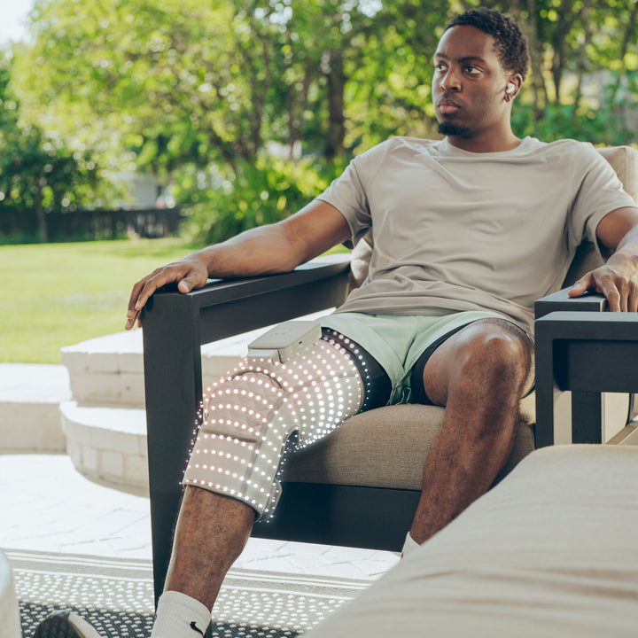 Close up view of a man relaxing with Homedics® Modulair compression knee wrap.