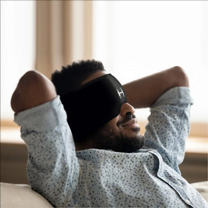 A Man using the Homedics Hot and Cold Relief Gel Head Sleeve while resting