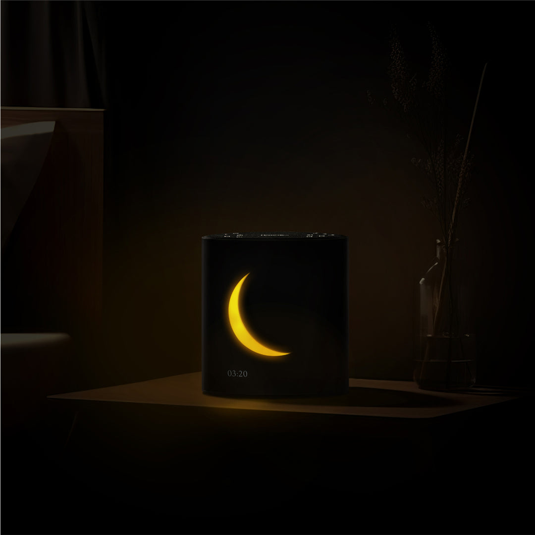 Night image of Sound Sleep Moon Dream Sound Machine & Clock displaying time and lunar visuals on display screen.