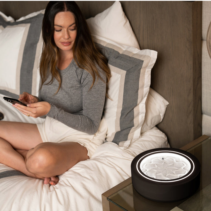 Black | woman winds down in bed while gazing into the black drift 11"