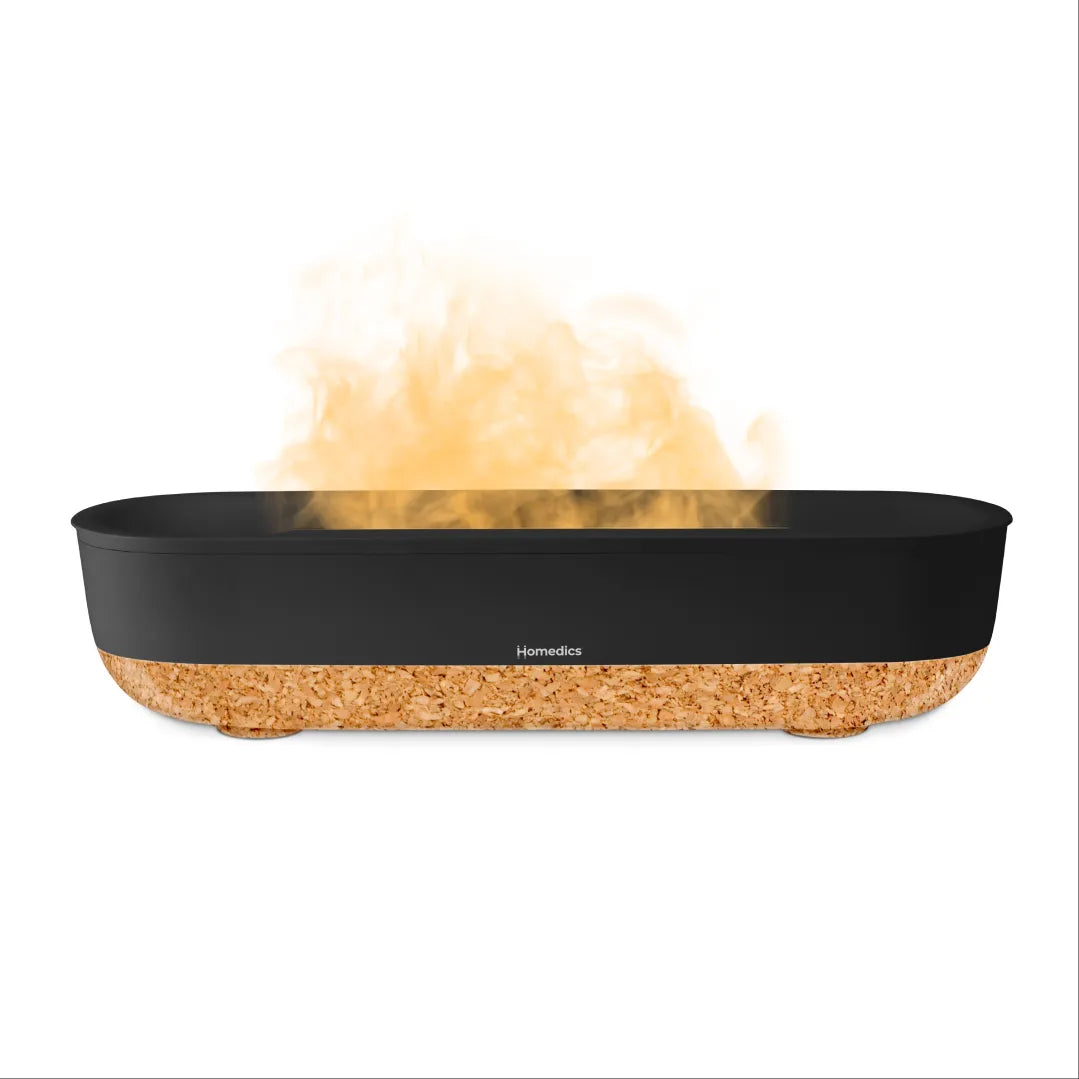 A woman listens to music and adds more water to the Fireside Ultrasonic Humidifier