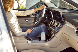 TotalComfort® Portable Ultrasonic Humidifier placed in a cupholder being used while driving in the car