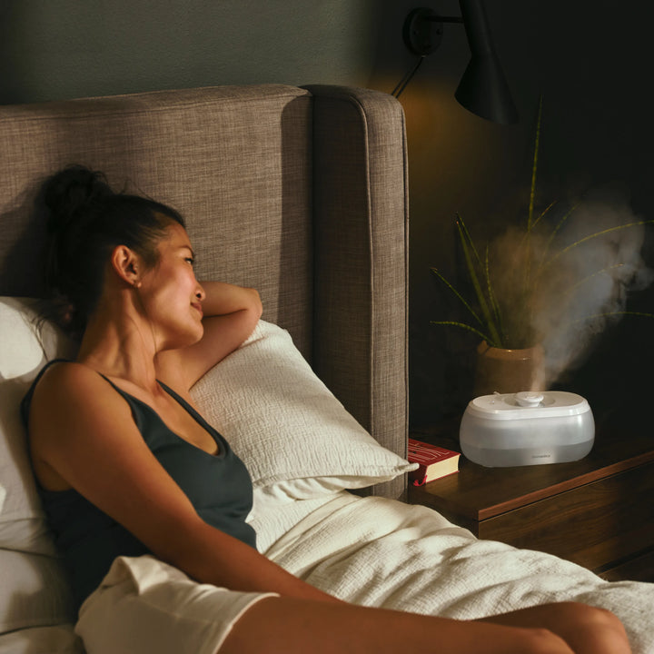 Homedics® Ultrasonic Humidifier CMTF14 releases moisture into her bedroom