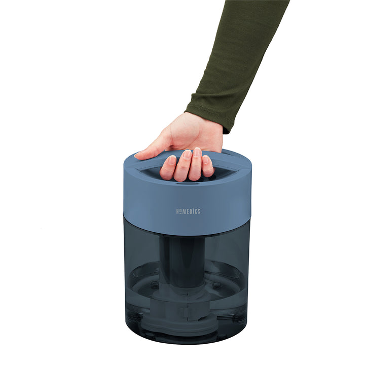 Blue | Customer grabbing handle of the Homedics TotalComfort UV-C Ultrasonic Humidifier