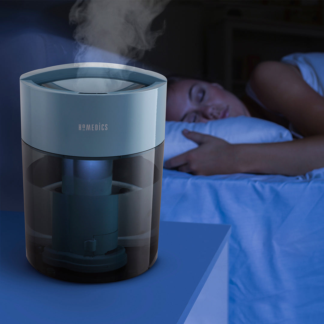 Blue | Homedics TotalComfort UV-C Ultrasonic Humidifier on nightstand humidifying air while customer sleeps soundly