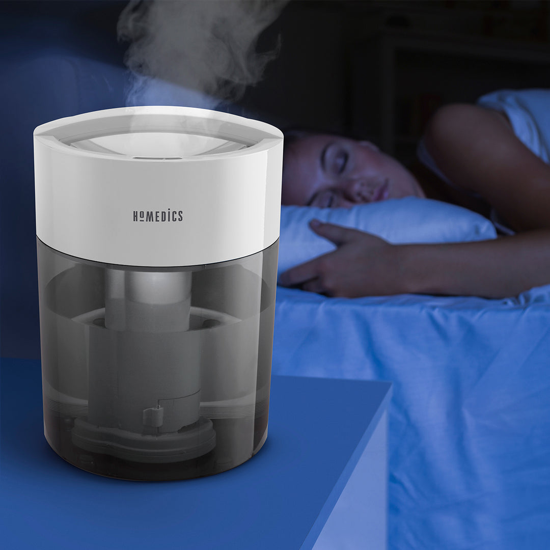 Grey | Homedics TotalComfort UV-C Ultrasonic Humidifier on nightstand humidifying air while customer sleeps soundly
