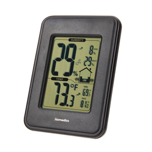 Homedics Indoor Humidity Monitor sits on living room table as couple sits on couch