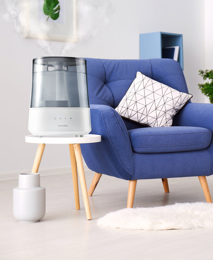 images shows Homedics® Warm/Cool Ultrasonic Humidifier placed in a living room