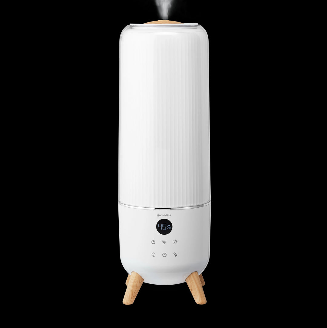 Person fills tank of the Homedics TotalComfort® Deluxe Large Room Ultrasonic Humidifier. Large top-fill tank, up to 70-hour runtime, 1.47-gallon capacity and easy to fill & clean