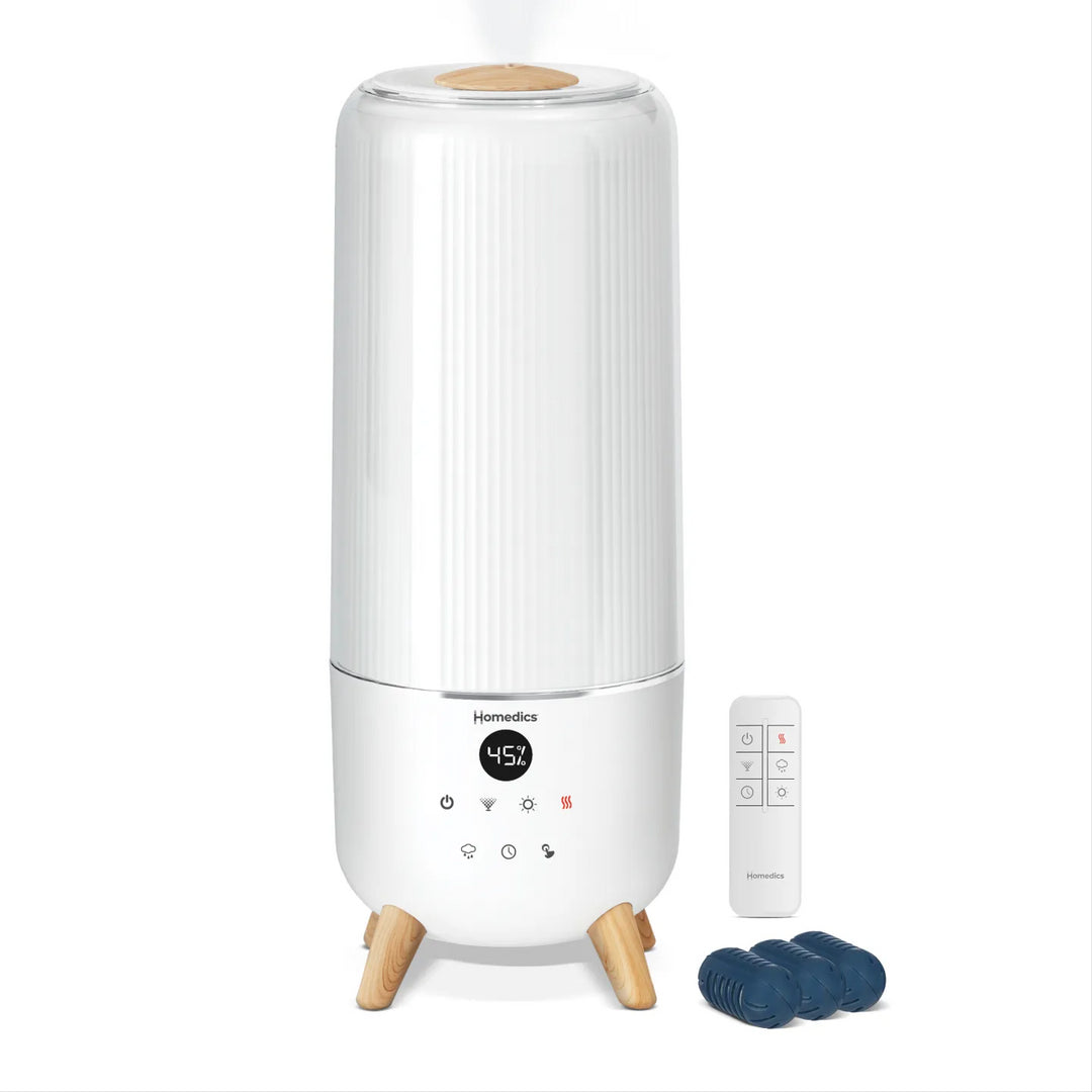 Image of a woman using the Homedics® Warm & Cool Mist Ultrasonic Humidifier while working.