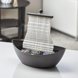 Angled view of the Homedics White Waters Relaxation Fountain sitting on a white table