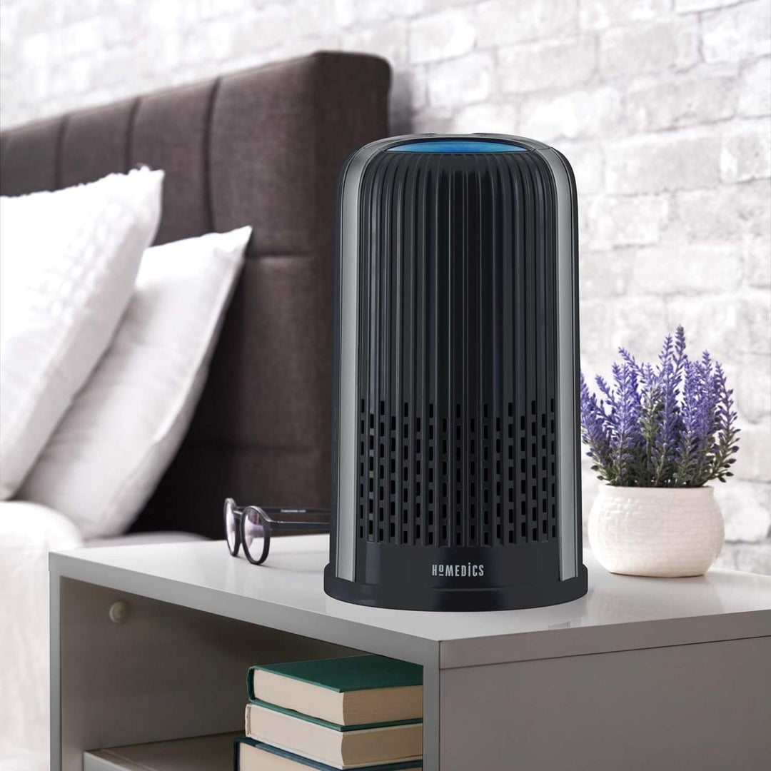 Black | Black Homedics TotalClean 4-in-1 Small Room Air Purifier sitting on bedroom table
