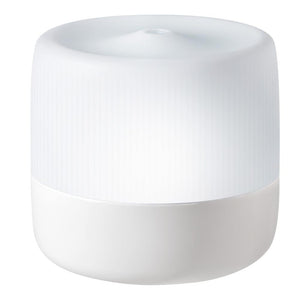 Homedics Ultrasonic Aroma Diffuser on desk next to bed