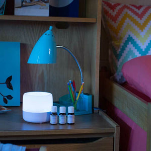 Homedics Ultrasonic Aroma Diffuser on desk next to bed