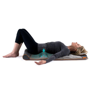 Side view of woman laying on Homedics Air Compression Back Stretching Mat
