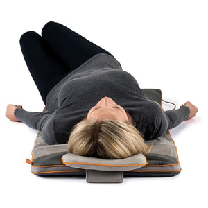 Front view of woman laying on the Homedics Air Compression Back Stretching Mat