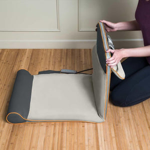 Woman folds Homedics Air Compression Back Stretching Mat