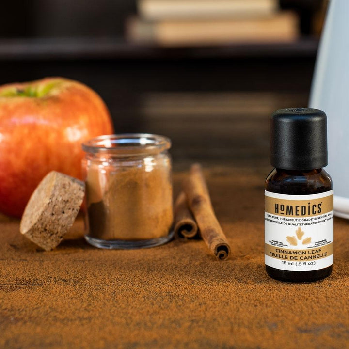 Homedics Cinnamon Leaf Essential Oil 15 ml next to bottle of ground cinnamon and cinnamon sticks