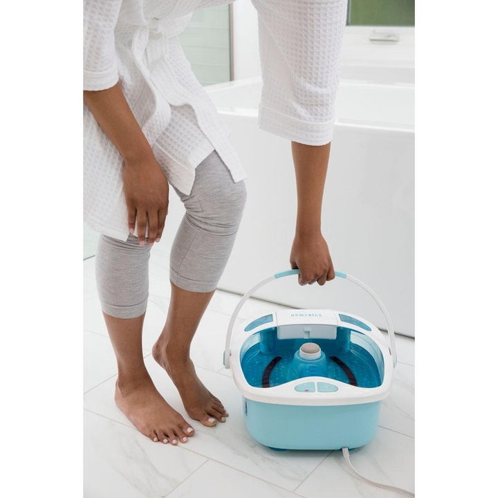 Person holds the carry handle for the Homedics Shower Bliss Foot Spa