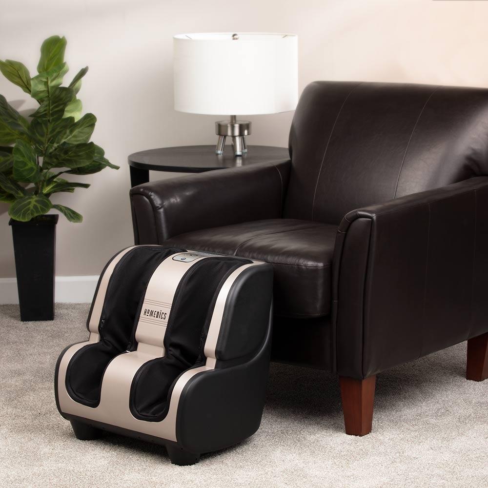 Angled view of the Homedics Therapist Select 2.0 Foot and Calf Massager with Soothing Heat on floor in front of chair