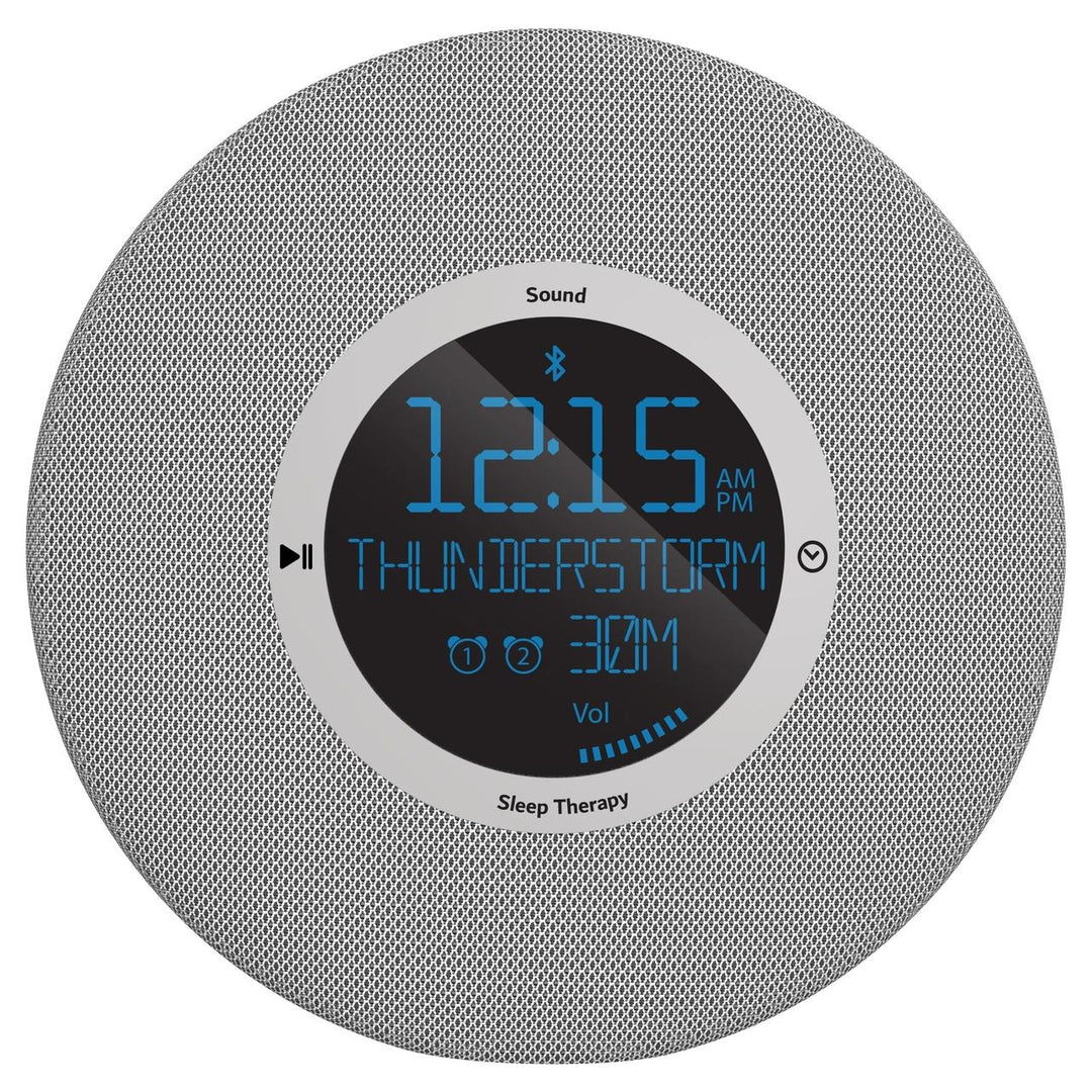 Homedics Deep Sleep Revitalize Engineered Sleep Sound Alarm Clock on nightstand next to bed