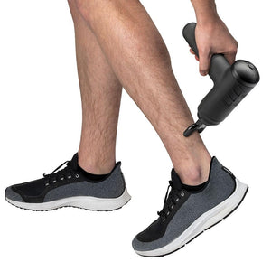 Man massages lower left leg with the Homedics Therapist Select Percussion Massager