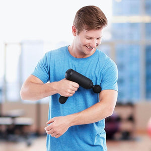 Man massages left bicep with the Homedics Therapist Select Percussion Massager