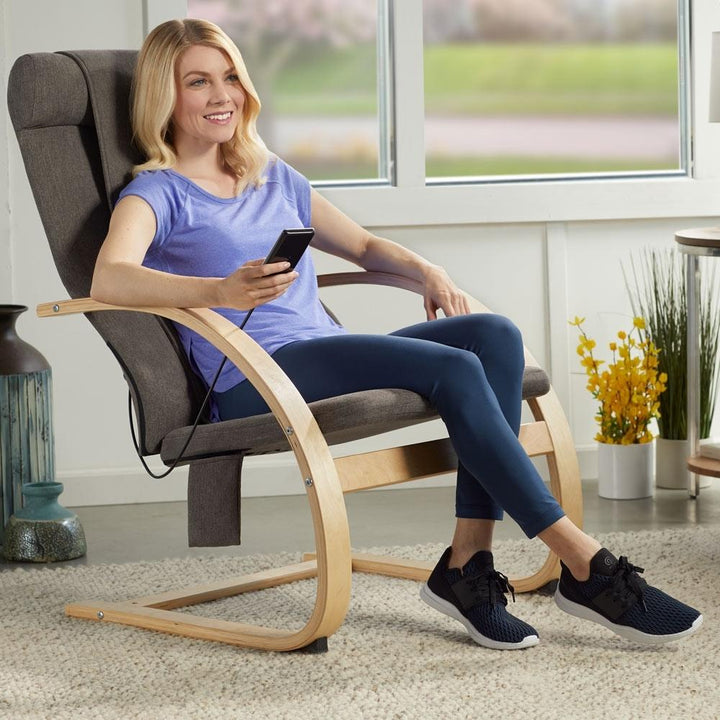 Woman sits in chair and enjoys a massage from the Homedics 3D Shiatsu Massaging Lounger