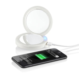 Angled view of Homedics Compact Charging LED Mirror with Rechargeable Light attached to phoone