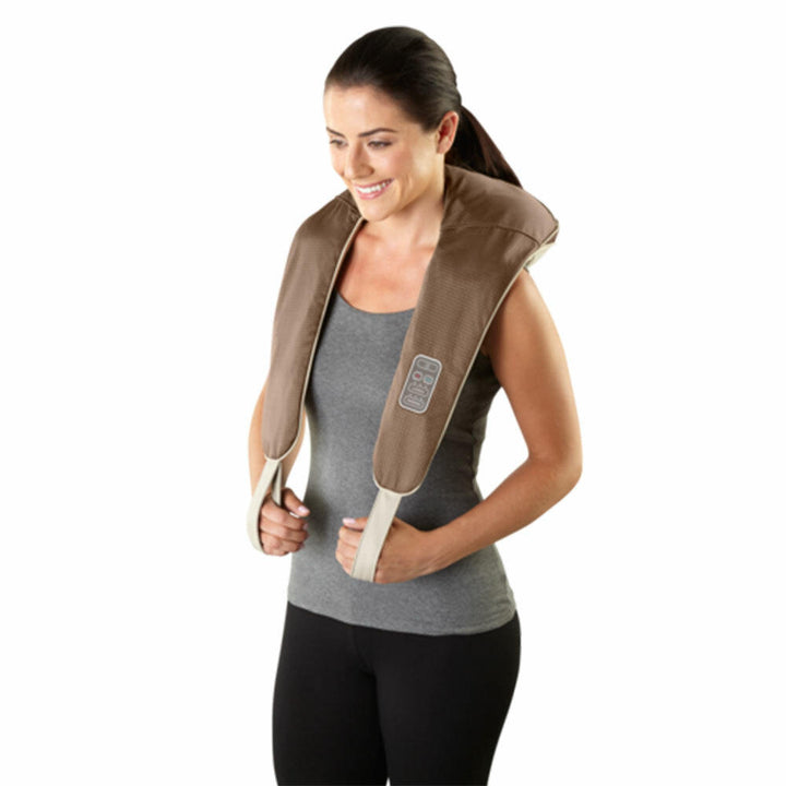 Standing woman enjoys shoulder massage with the Homedics Back and Shoulder Percussion Massager with Heat