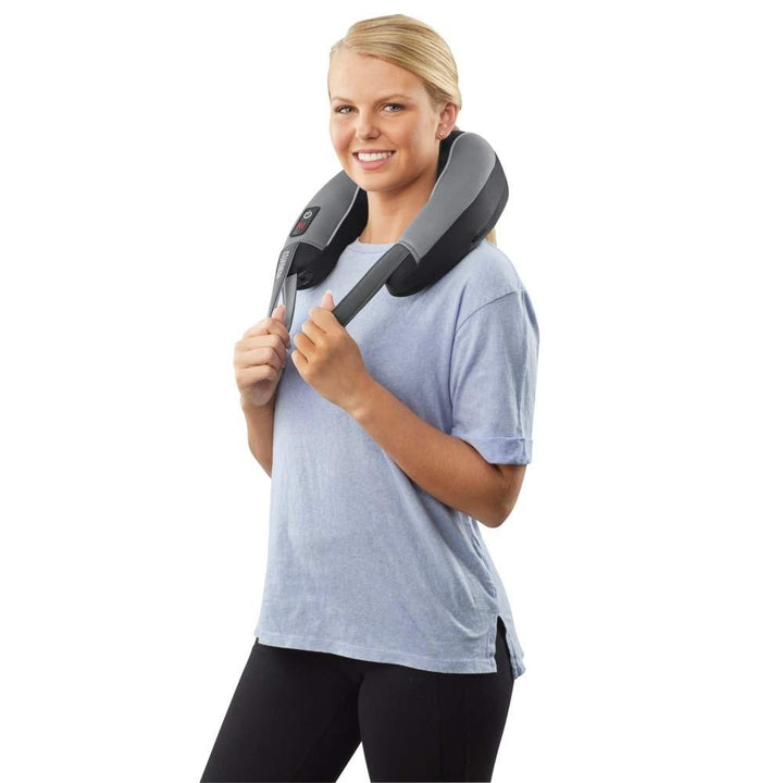 Standing woman smiles while enjoying neck massage from the Homedics Pro Therapy Vibration Neck Massager with Heat