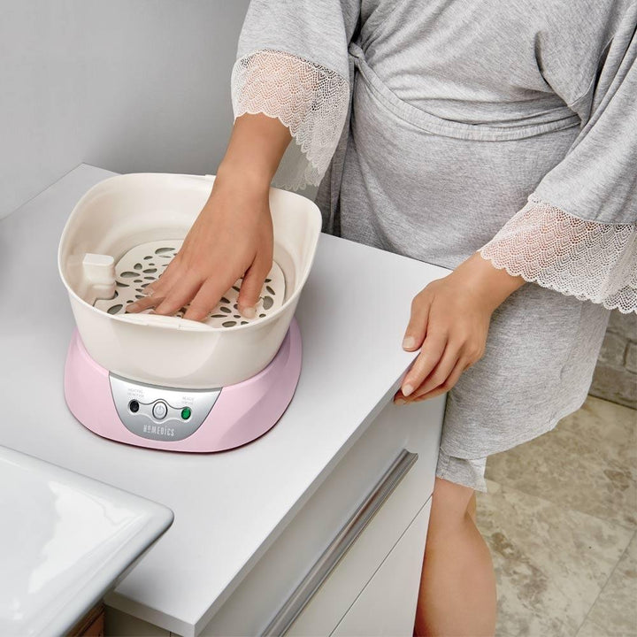 Hand inside the Homedics Pink ParaSpa Plus Paraffin Bath